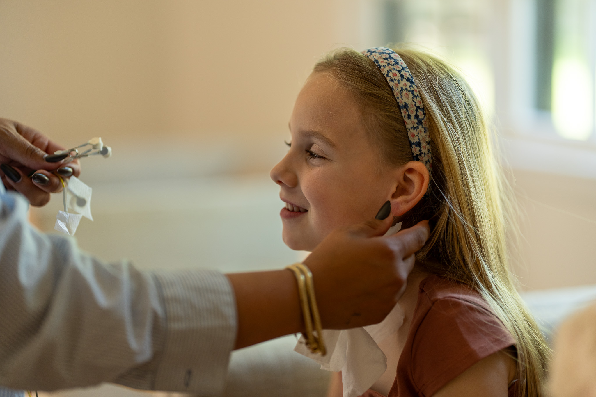 A soft LENS sensor placed gently at the ear during a calm, quiet session