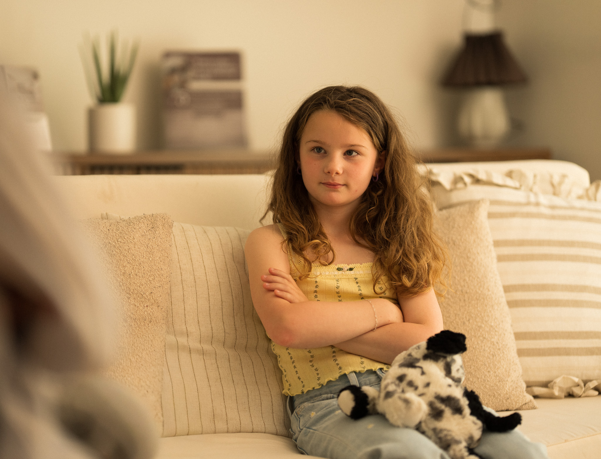 A teen girl sitting on a couch